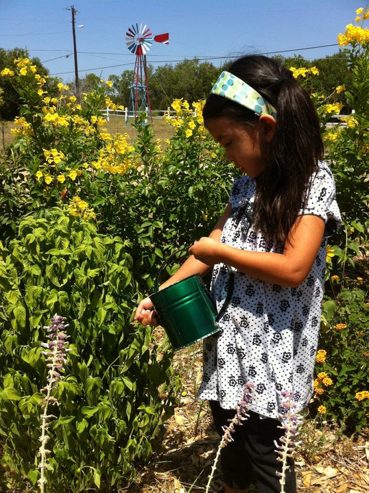 girl watering garden
